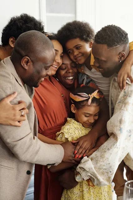 A family sharing a joyful group hug